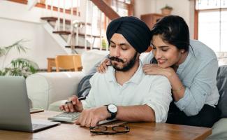 Happy couple looking at a calculator